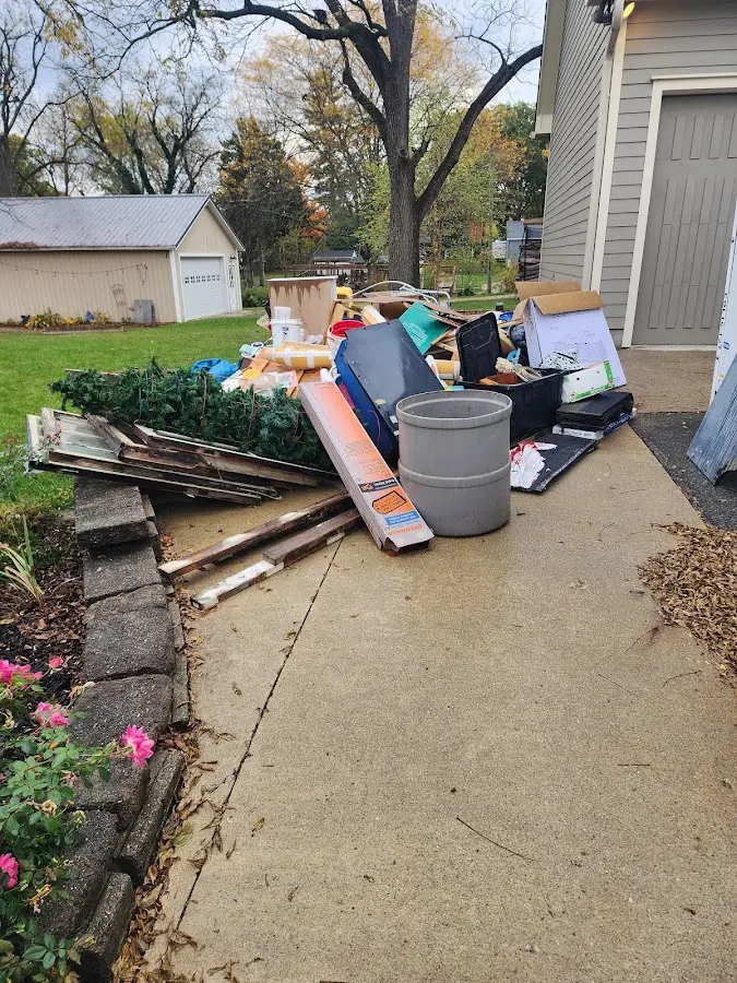 Dumpster being loaded with debris for Estate Cleanout Dumpster Rental in Bernardsville
